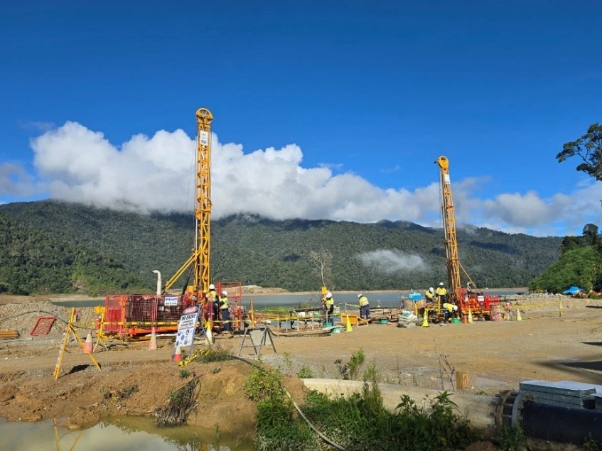 Twin heli-supported diamond drill rigs on a remote pad in Papua New Guinea